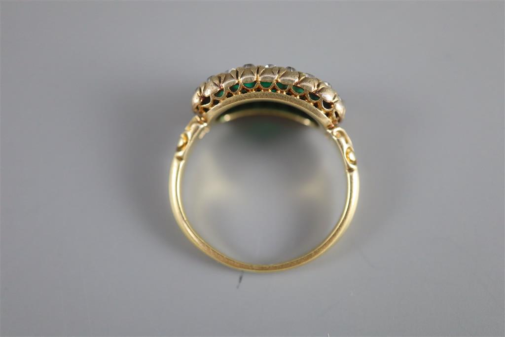 A late Victorian gold, graduated five stone emerald and diamond cluster half hoop ring,